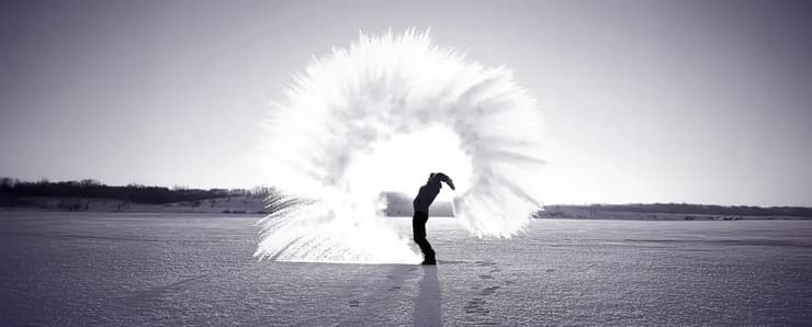 אדם מעיף מים חמים שקופאים באוויר (צילום: Kichigin/Shutterstock) אדם מעיף מים חמים שקופאים באוויר