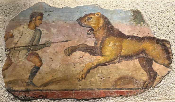 ציור קיר רומי המציג אדם נלחם באריה (איור: Museo Nacional de Arte Romano (MNAR), número de inventario CE26719) ציור קיר רומי המציג אדם נלחם באריה