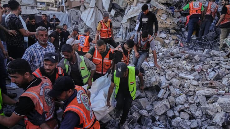 פינוי גופה מזירת המבנה שקרס (צילום: AP Photo/Jehad Alshrafi) הרוגים ונעדרים בקריסת מבנה ששימש למגורי עקורים במערב עזה