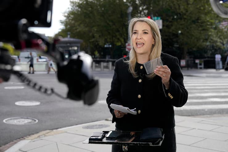 כתבת CNN בטסי קליין משדרת מהרחוב ליד הבית הלבן, ומציגה את כיסוי הפלסטיק - שבו היה אישור הכניסה שלה שנלקח ממנה (צילום: AP Photo/Jose Luis Magana) כתבת CNN בטסי קליין משדרת מהרחוב ליד הבית הלבן אחרי החרם איסור כניסה של נשיא ארה"ב טראמפ