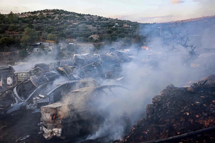 האש בעין יברוד, אתמול (צילום: Zain JAAFAR / AFP) לוחם אש פלסטיני פועל לכיבוי שריפה במגרש גרוטאות עין יברוד שליד רמאללה