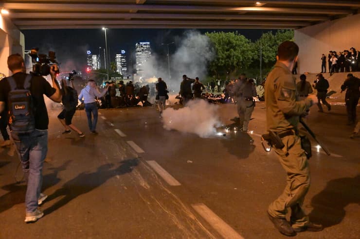 רימוני הלם מושלכים לעבר המפגינים (צילום: יובל חן ) חרדים מפגינים בכביש 4 במחלף גהה