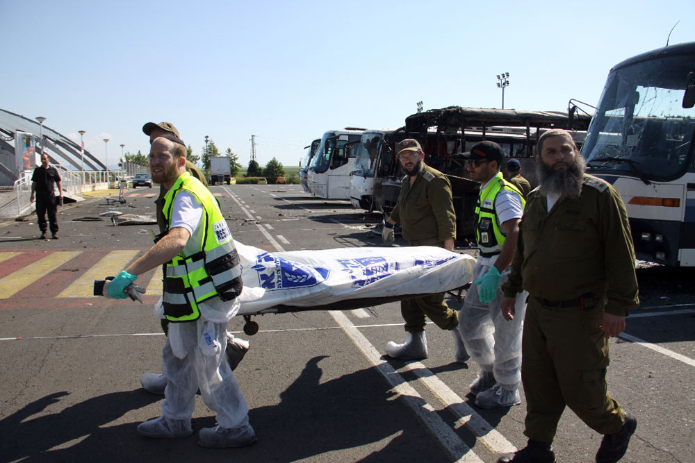 Health workers at Burgas Airport preparing to move the body of one of the attack's victim back to Israel 