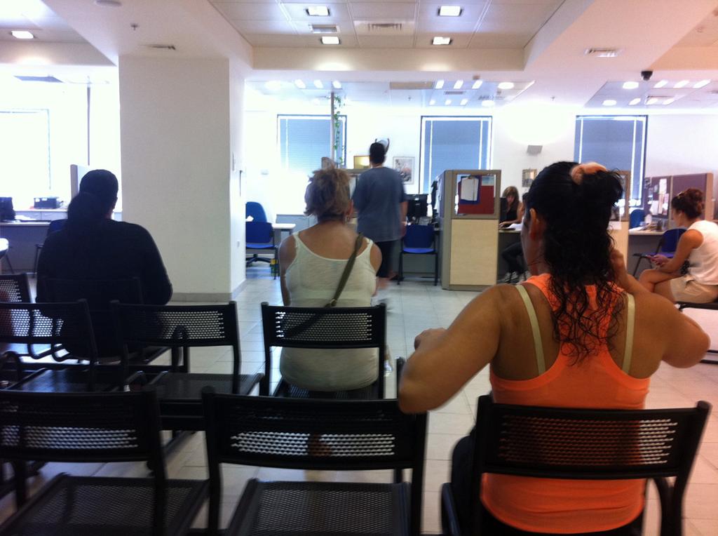 Israelis waiting in line at an unemployment bureau