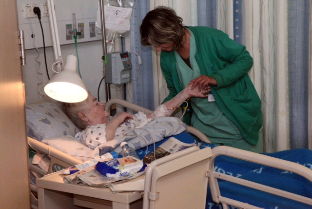 Nurse treating a patient at Tel Aviv's Ichilov Hospital 