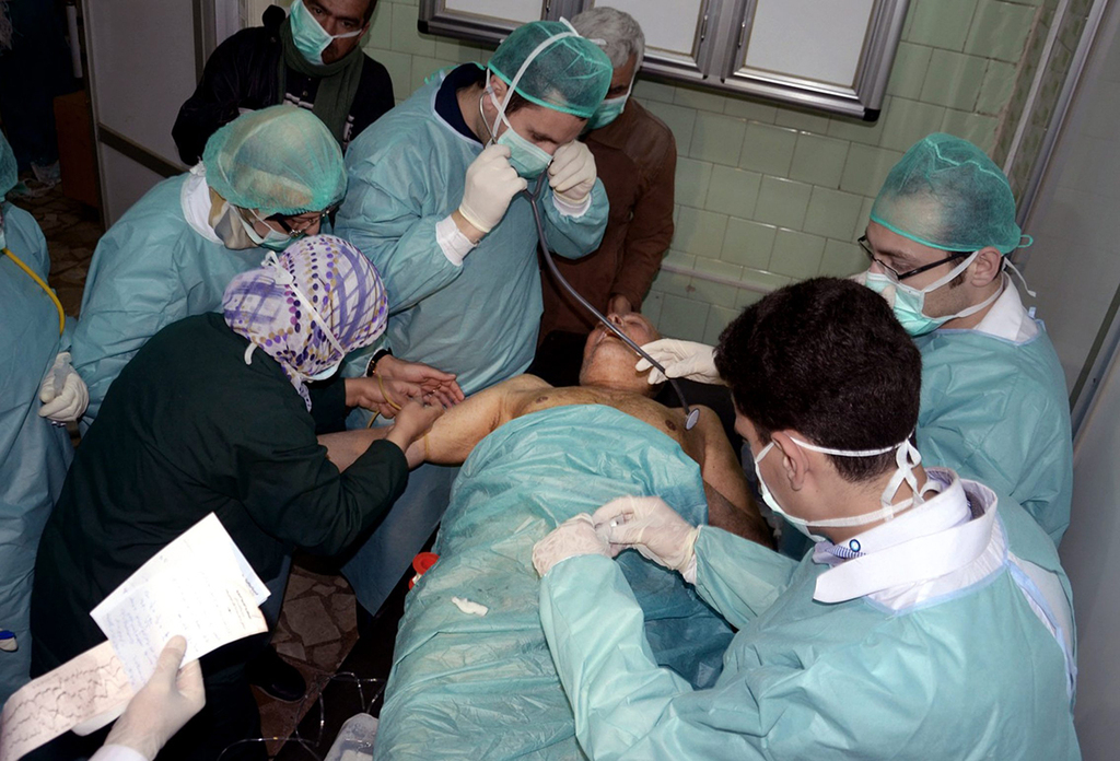 Doctors treat a victim of a chemical attack in Aleppo in 2013