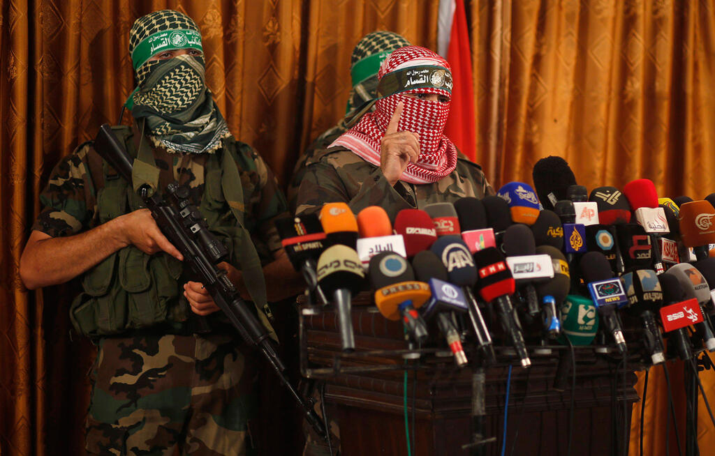 Members of Hamas' military wing holding a press conference in 2014 