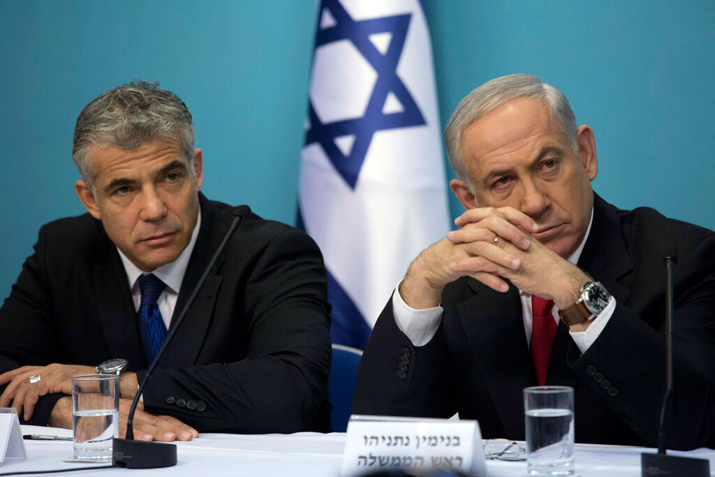 Then-Finance Minister Yair Lapid and Prime Minister Benjamin Netanyahu 