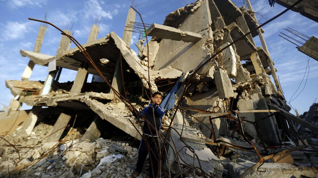 A Palestinian child in the rubble in Gaza during the 2014 war 