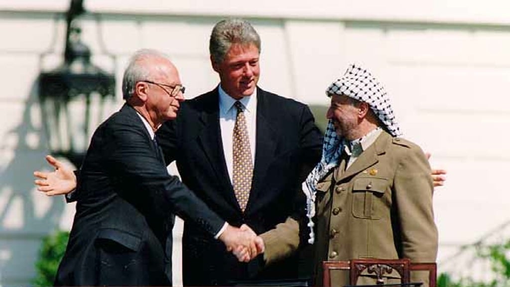Prime Minister Yitzhak Rabin, U.S. President Bill Clinton and Palestinian President Yasser Arafat at the signing of the first Oslo Accords in 1993 