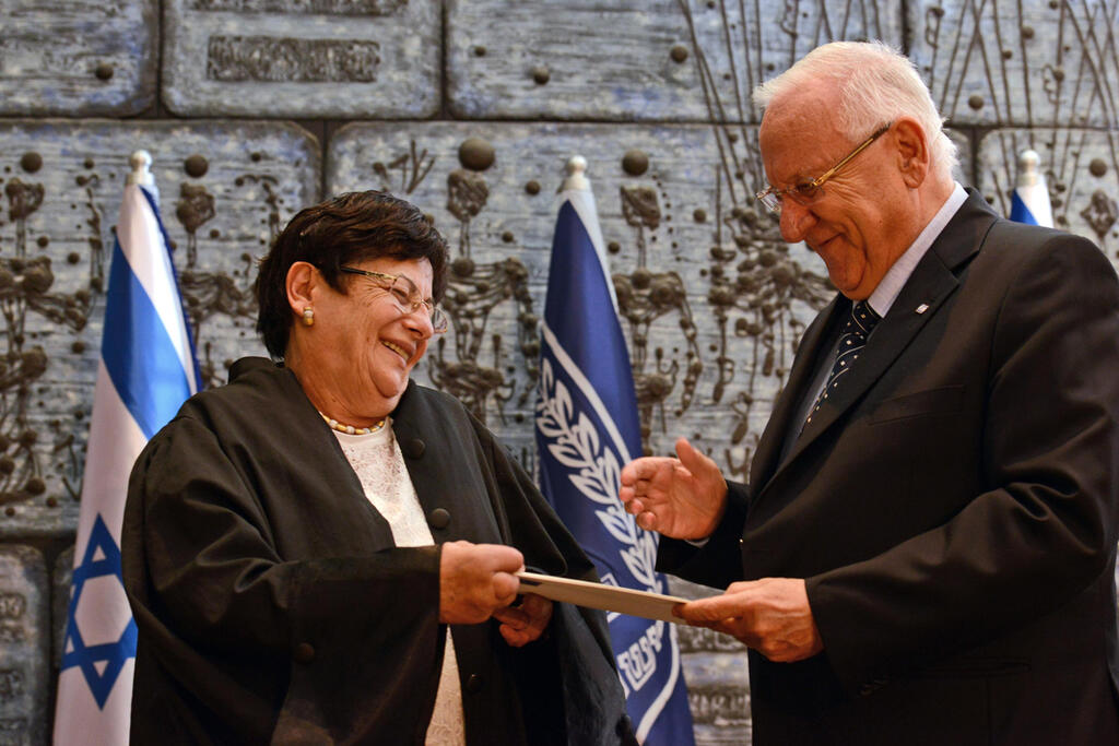 Naor and then-president Reuven Rivlin seen smiling during her swearing-in ceremony as Supreme Court chief justice, January 15, 2015 