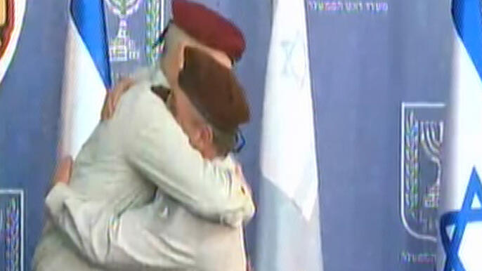 Benny Gantz and Gadi Eizenkot share an embrace as the latter leaves the army in the hands of a new chief of staff  in 2015 