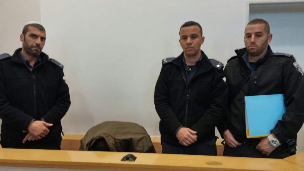 Michael Peretz hiding beneath a coat during a 2015 court appearance 