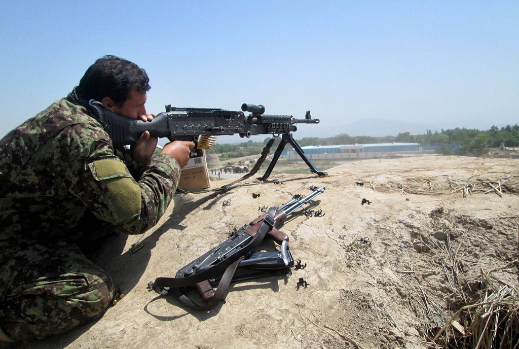 Afghan security forces soldier firing at Taliban positions 