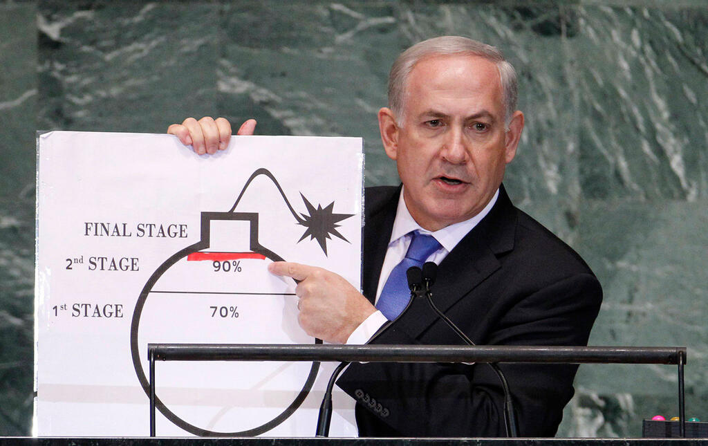 Benjamin Netanyahu holds up a diagram featuring a cartoonish drawing of a bomb he used as a prop to illustrate what he sees as Iran's drive for an atomic weapon during his speech at the UN General Assembly, September 27, 2012 
