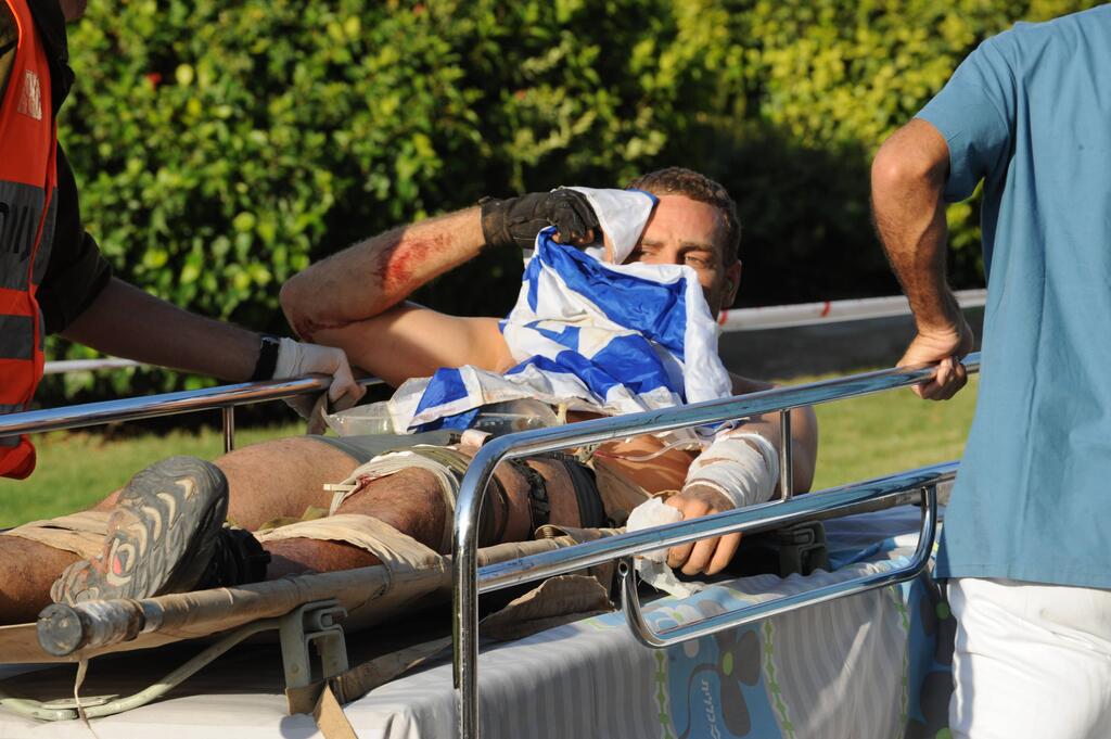 Michaeli wrapped in Israel flag while evacuated   
