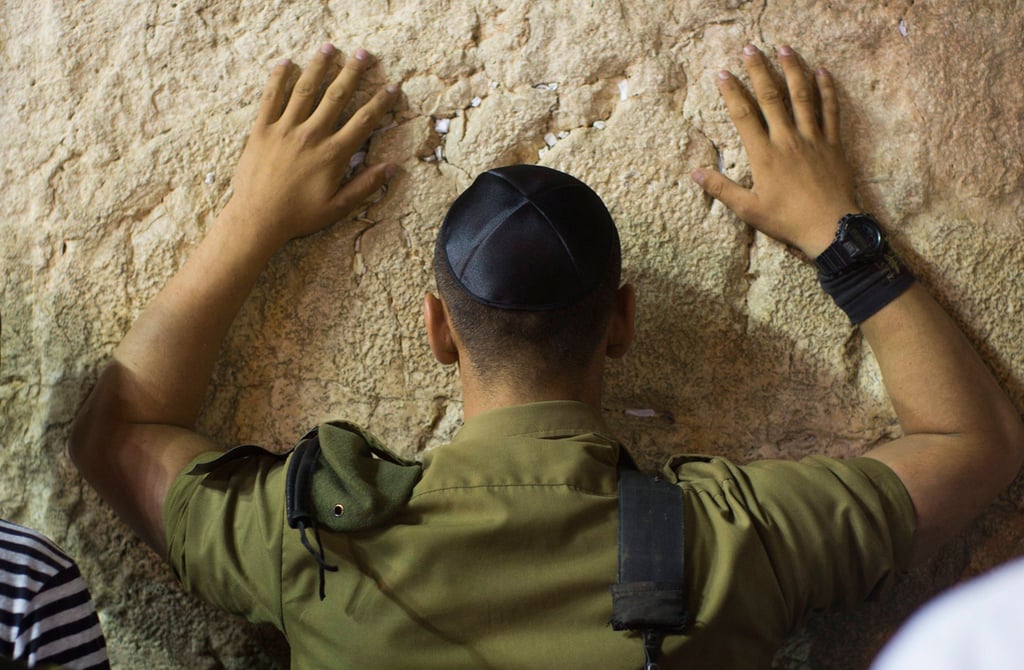An IDF soldier prays at the Western Wall in Jerusalem during Yom Kippur 