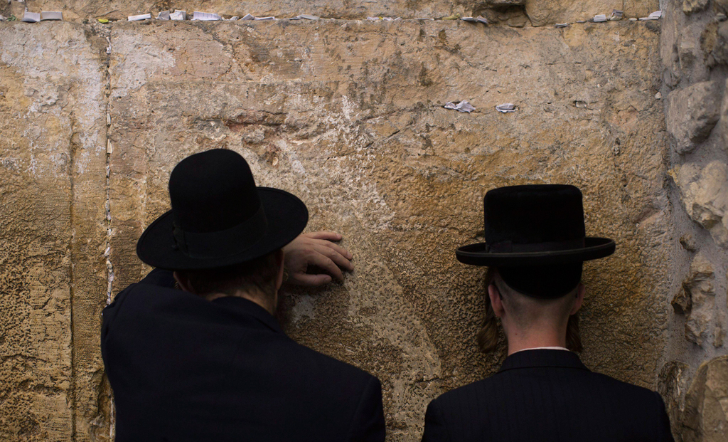 Ultra-Orthodox men praying at the Western Wall in Jerusalem 