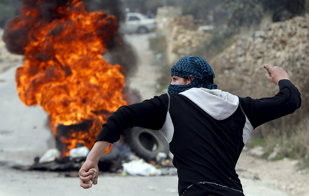Palestinians throw rocks and set tires of fire at riots in Israel 