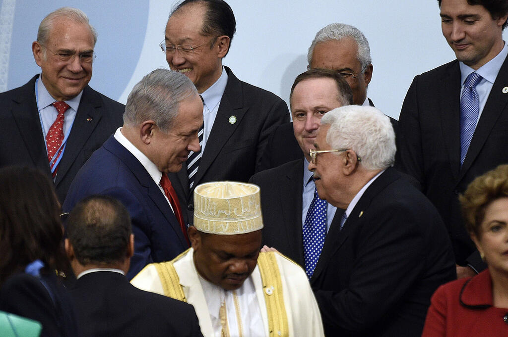Prime Minister Benjamin Netanyahu and Palestinian President Mahmoud Abbas meeting during an international climate summit in Paris in 2015 