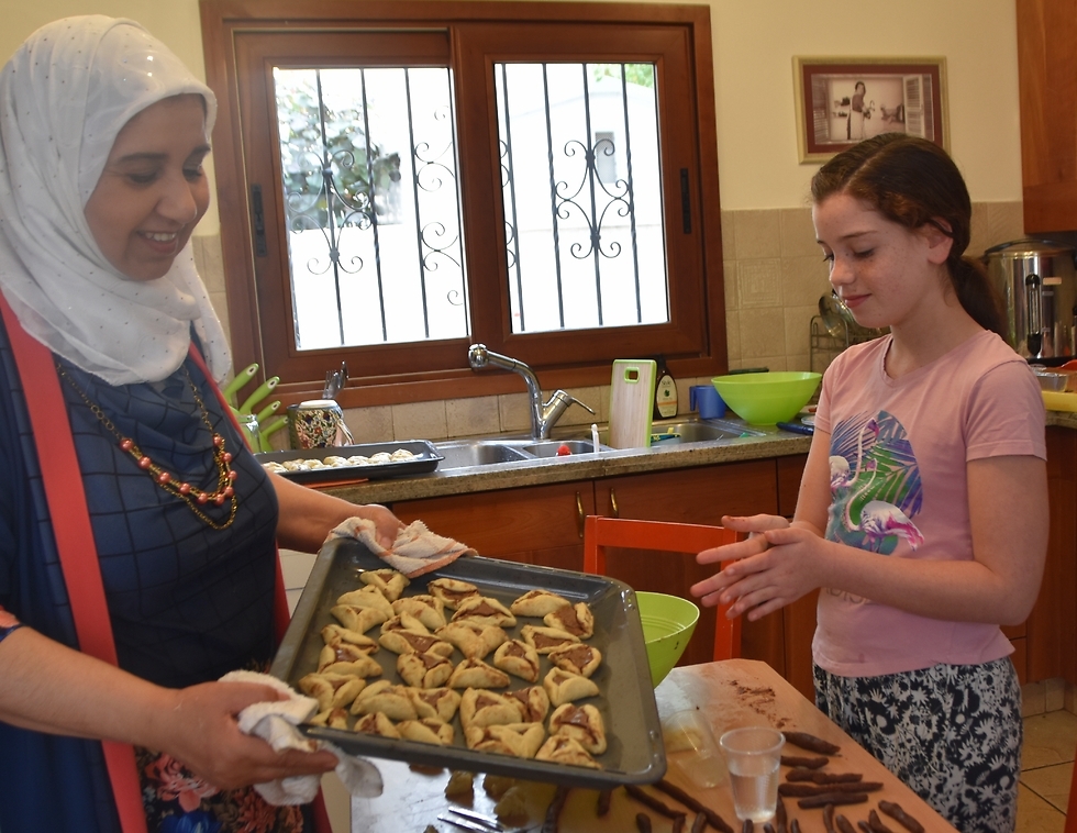 An Israeli Muslim and an Israeli Jew bake <i>hamantashen </i>for the upcoming Jewish holiday of Purim 