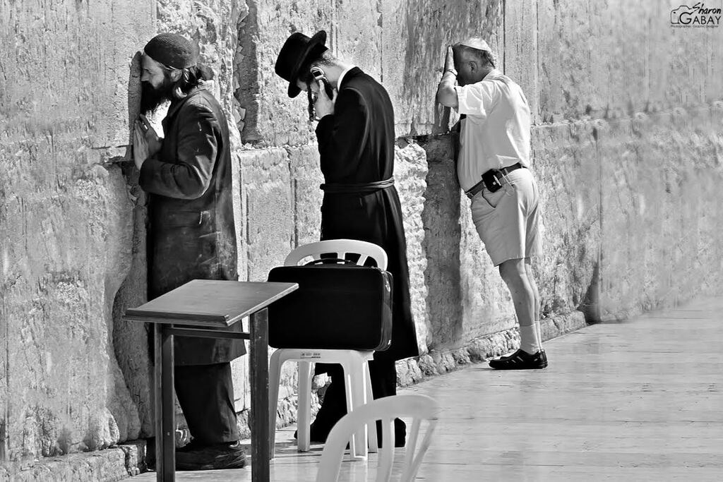 Secular and Haredi Jews praying side by side at the Western Wall in Jerusalem 
