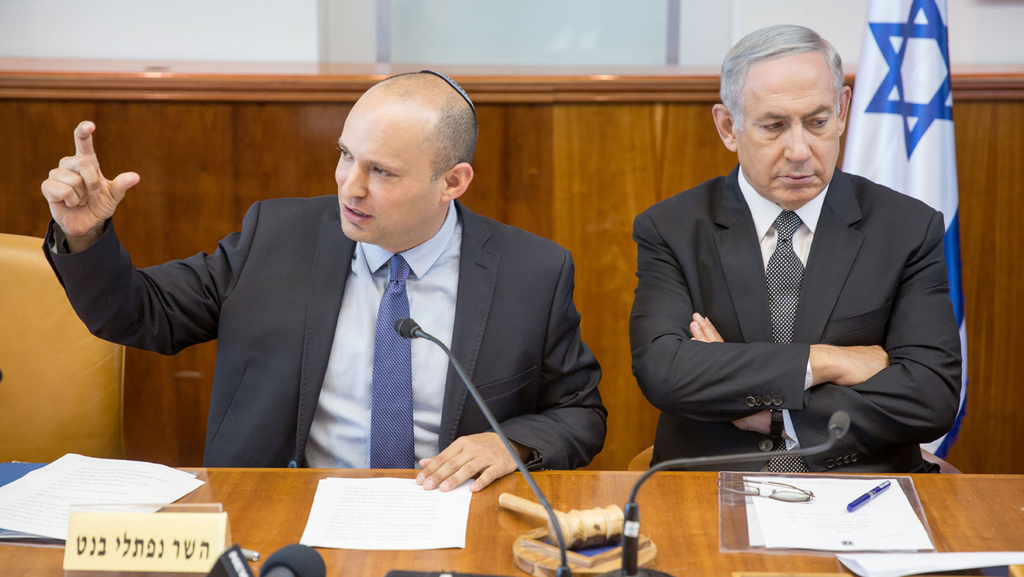 Then-economy minister Naftali Bennett with Benjamin Netanyahu in 2016 