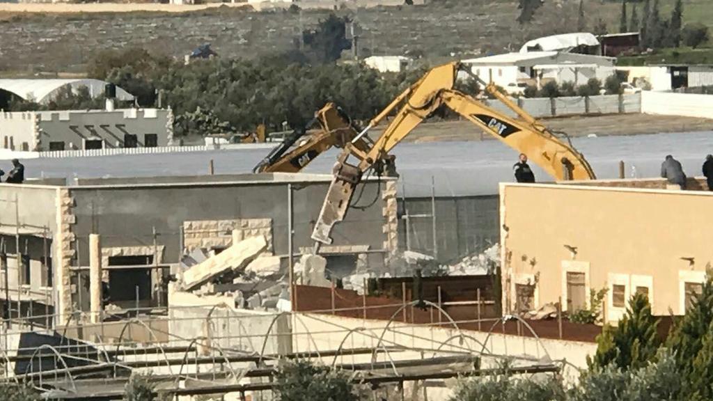 Authorities demolishing a house in the Arab city of Qalansawe