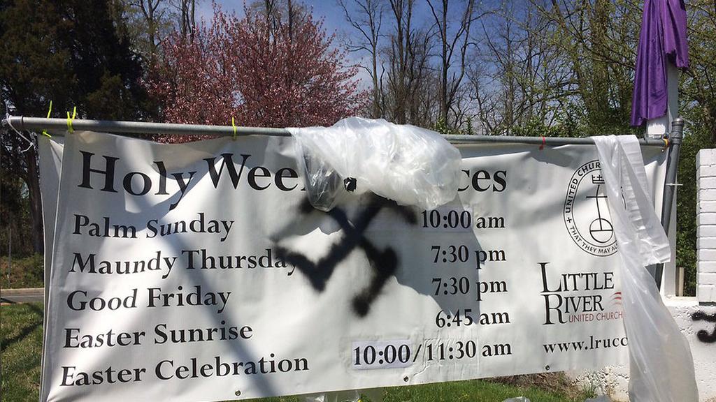 A swastika sprayed on a church banner in Virginia during Easter