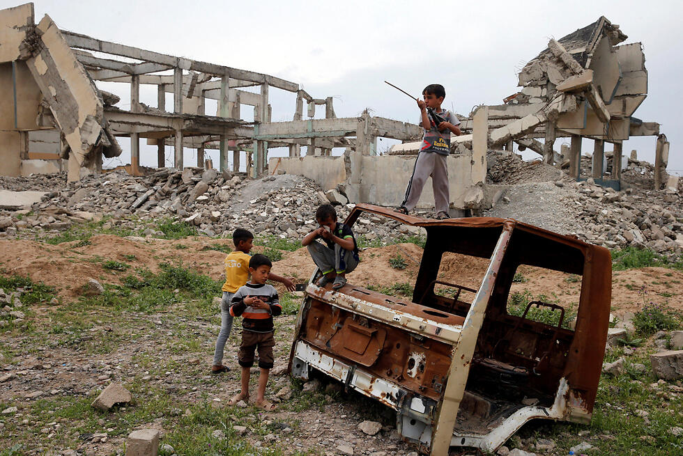 Children playing in the rubble, in Mosul, Iraq 