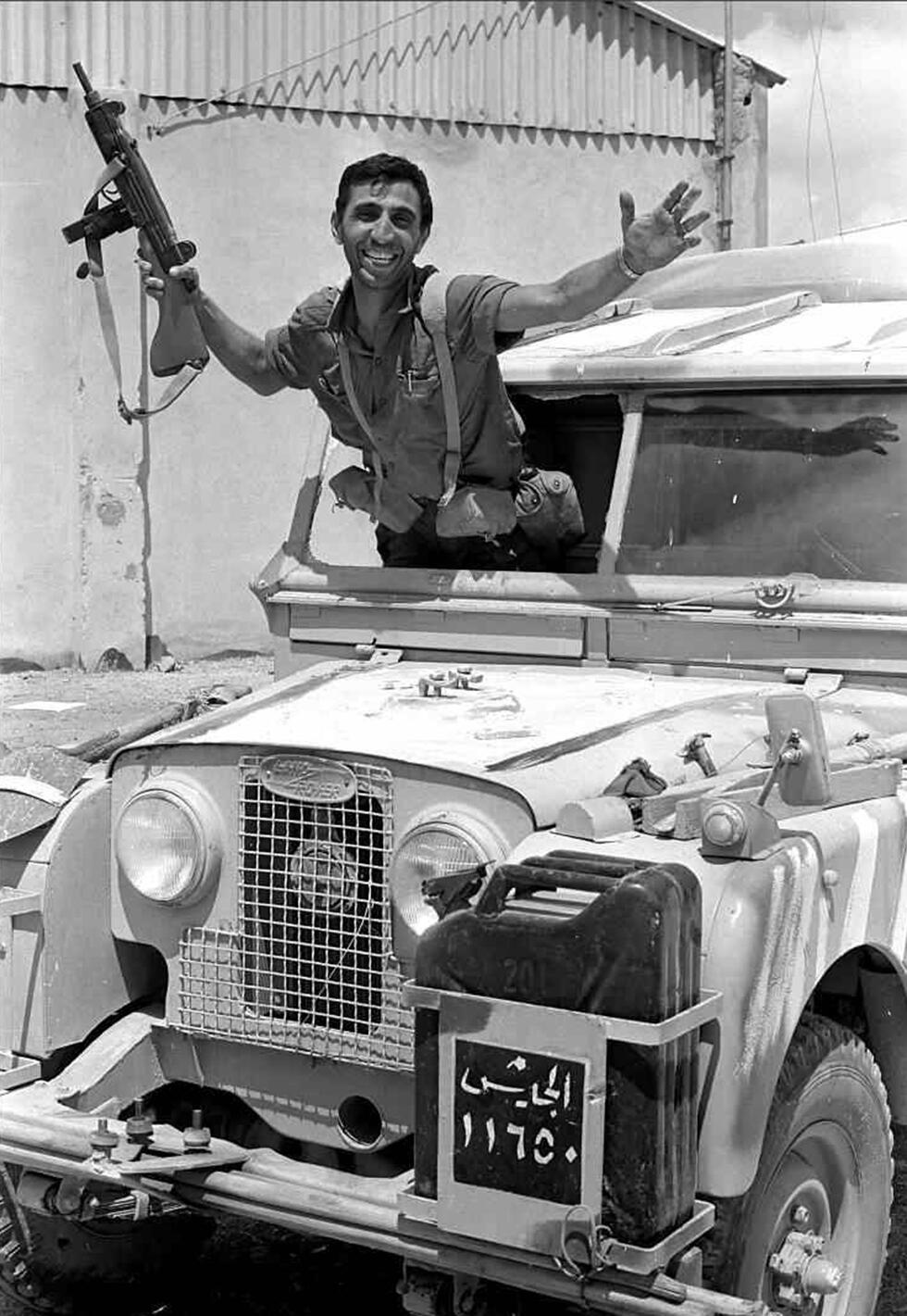 An IDF soldier celebrates the liberation of East Jerusalem in an abandoned Jordanian army vehicle 