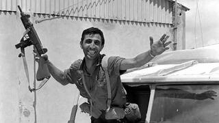An IDF soldier celebrates the liberation of East Jerusalem in an abandoned Jordanian army vehicle 