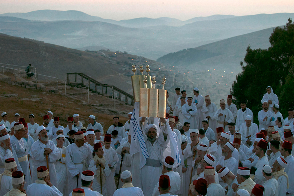 Samaritan worshipers pray on Mount Gerizim as they celebrate the Shavuot festival at dawn, June 2017 