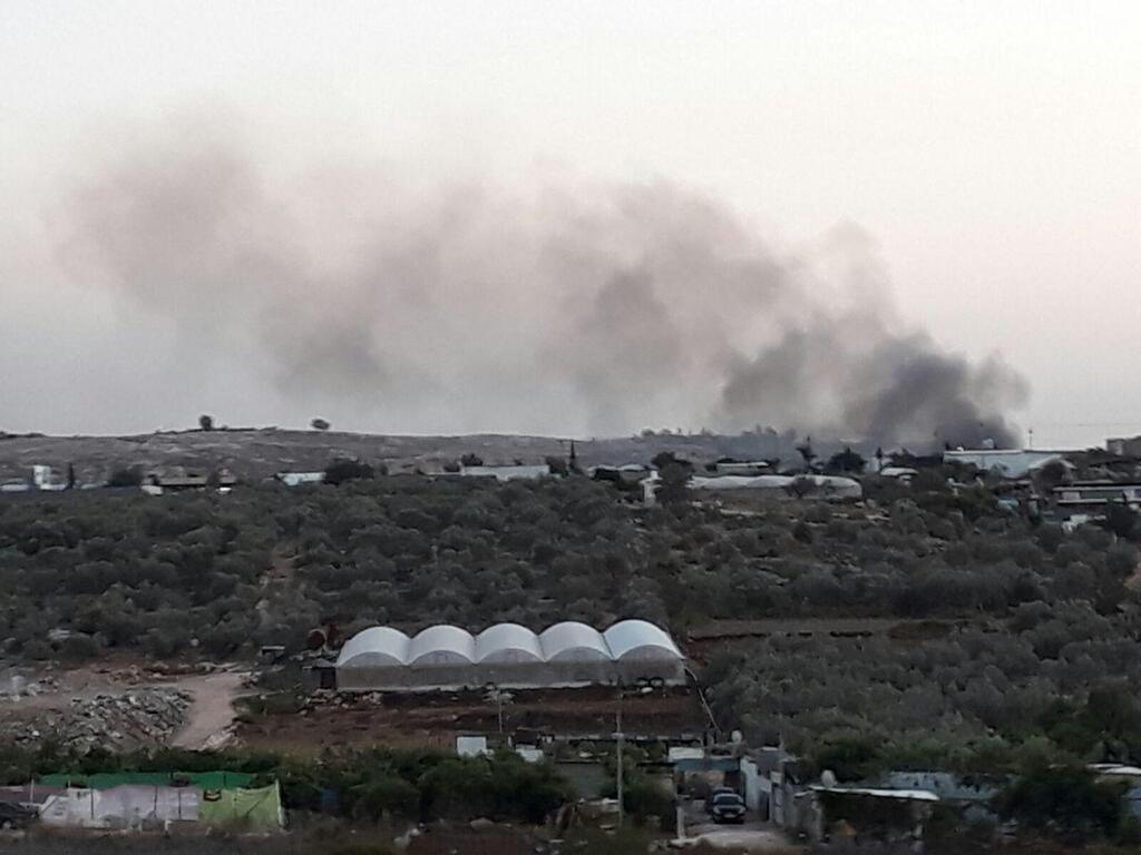 Smoke billowing from a controlled waste fire in the West Bank city of Qalqilya 