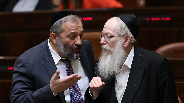 Interior Minister Aryeh Deri of Shas, left, and United Torah Judaism's leader Housing Minister Yaakov Litzman in the Knesset 