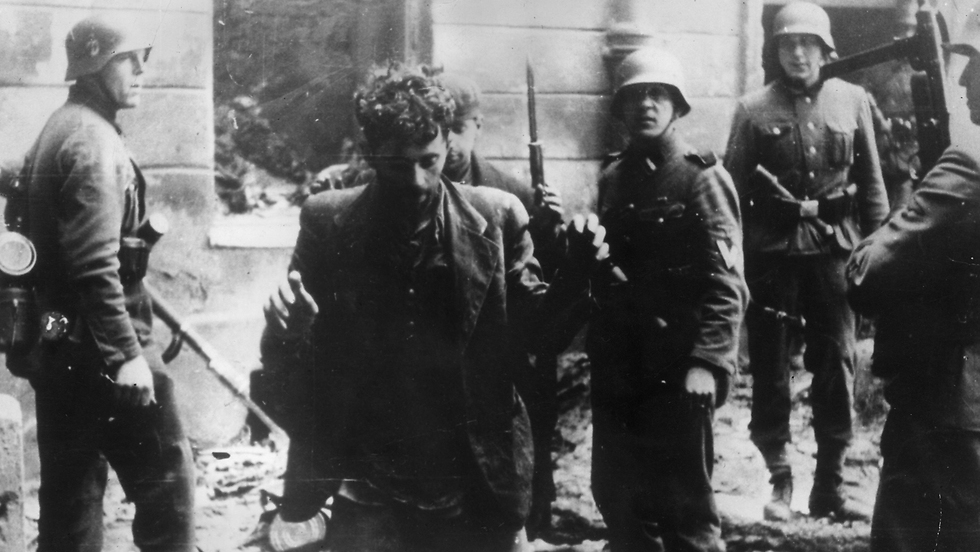 Nazi troops arresting a member of the Jewish resistance in the Warsaw Ghetto in 1943 