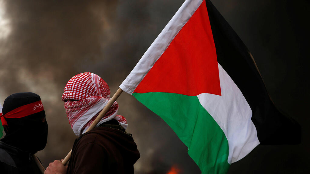 Men holding a Palestinian flag 
