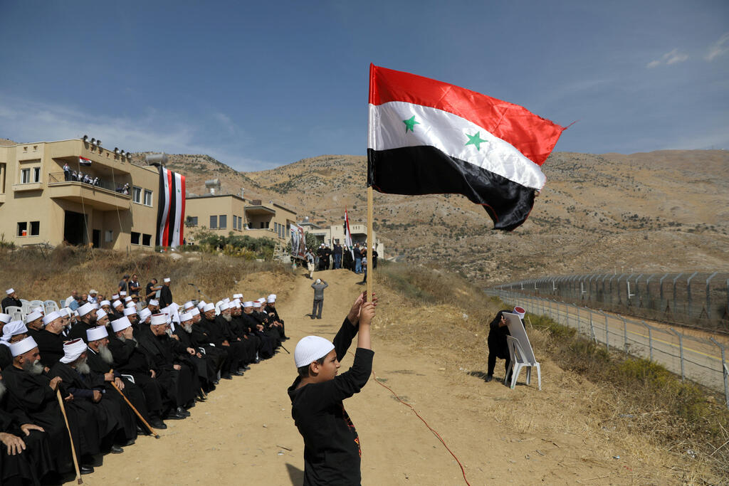 Druze residents of the Golan Heights attend a rally in support of Syrian President Assad in Majdal Shams