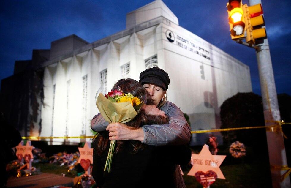 Mourners embracing outside Tree of Life Synagogue, in Pittsburgh (Photo: EPA) Mourners embracing outside Tree of Life Synagogue, in Pittsburgh