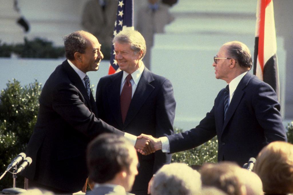 Egyptian President Anwar Sadat, U.S. President Jimmy Carter and Prime Minister Menachem Begin at the signing of the 1979 Israel-Egypt peace agreement 
