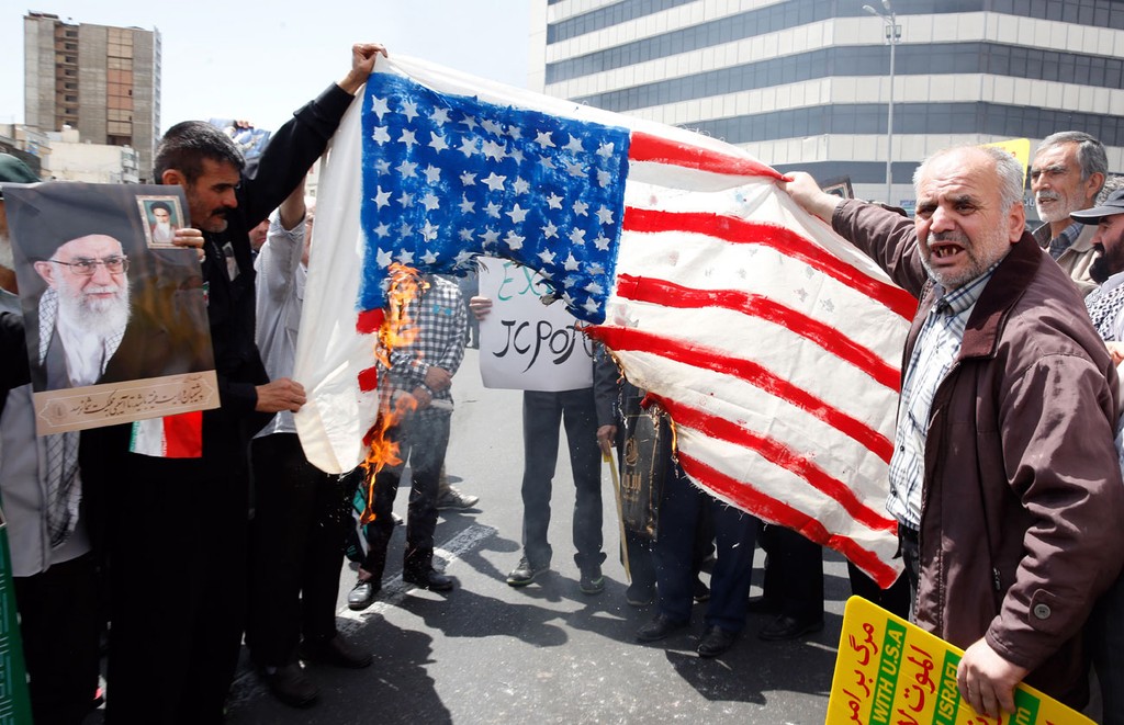 Iranians burn an American flag in Tehran after Trump pulled out of the Iran nuclear deal 