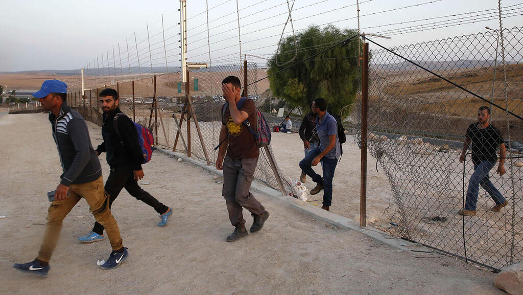 פועלים פלסטינים נכנסים לישראל דרך פרצה ב גדר ליד חברון