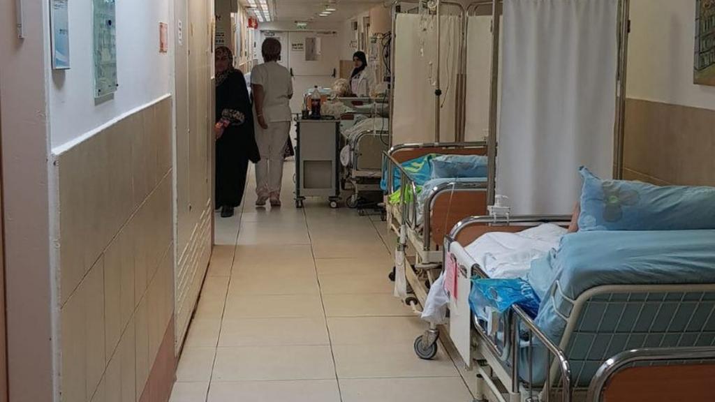 Patients waiting for treatment in hospital corridors