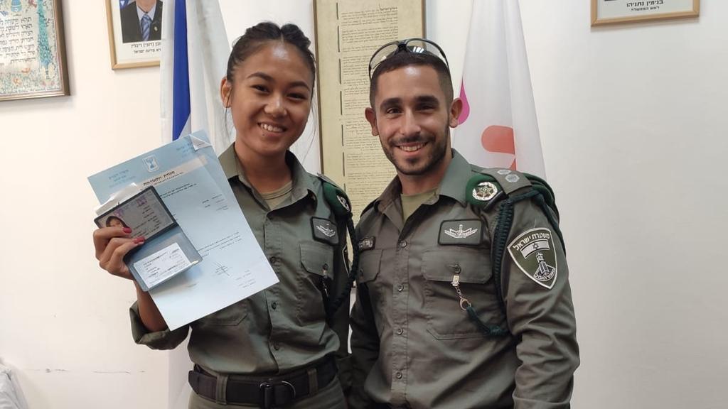 Jamaysa Yael Bontong poses with her new Israeli ID  and her commander Uri Levy  
