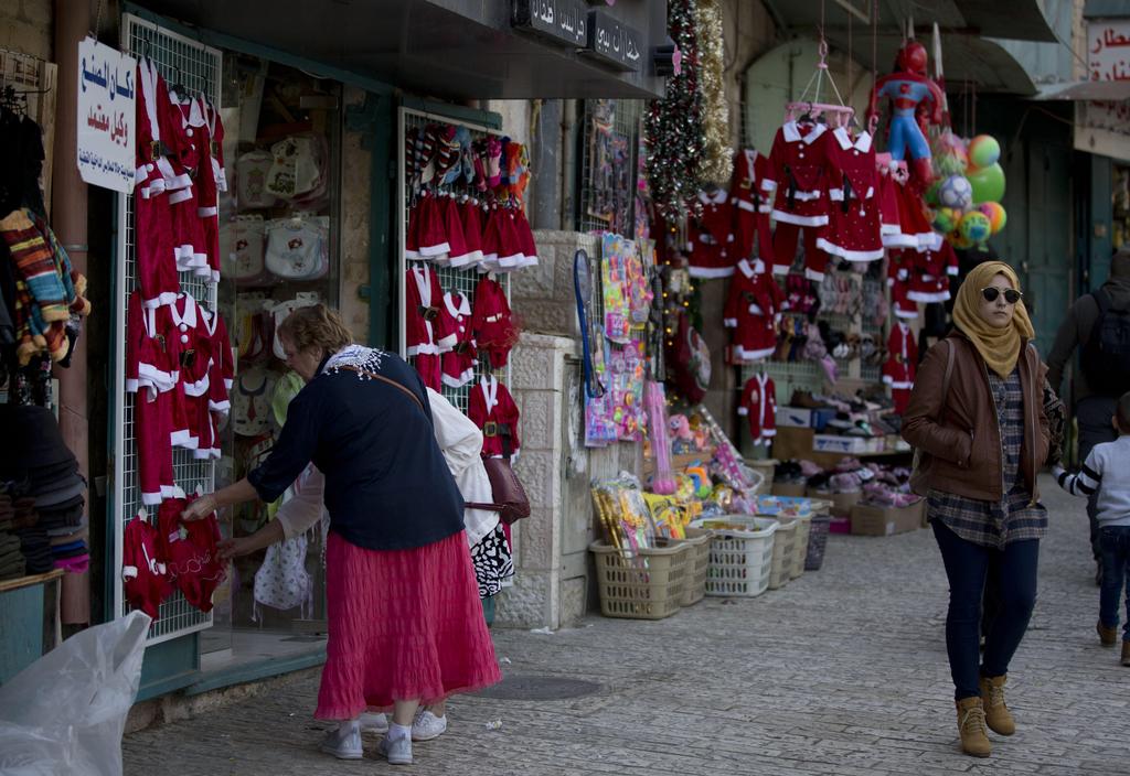 Christian visitors shop near the Church of the Nativity, traditionally believed by Christians to be the birthplace of Jesus Christ, in the West Bank city of Bethlehem, Dec. 5, 2019