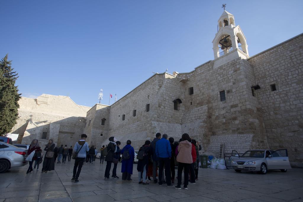 Christian visitors gather outside the Church of the Nativity, traditionally believed by Christians to be the birthplace of Jesus Christ, in the West Bank city of Bethlehem, Dec. 5, 2019 