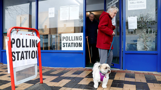 Woman accompanied by her dog at the polling station