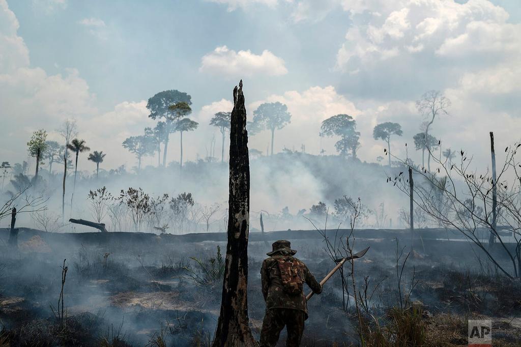 A Brazilian soldier puts out fires at the Nova Fronteira region in Novo Progresso, Brazil 
