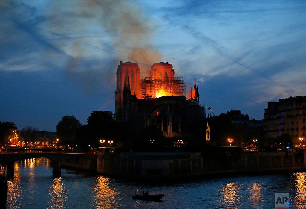 Flames and smoke rise from Notre Dame cathedral in Paris as firefighters tackle the blaze 