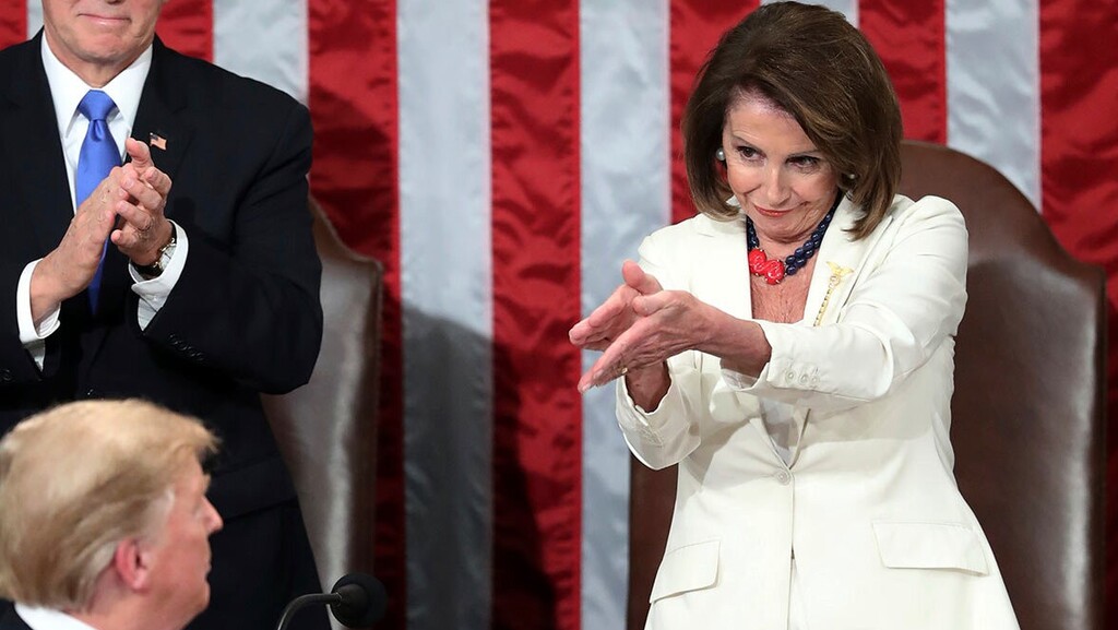 President Donald Trump turns to House Speaker Nancy Pelosi, as he delivers his State of the Union address to a joint session of Congress on Capitol Hill in Washington, as Vice President Mike Pence watches 